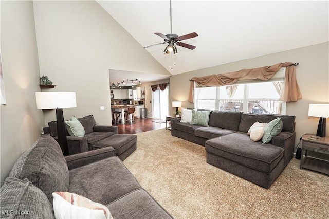 living room with a ceiling fan and high vaulted ceiling