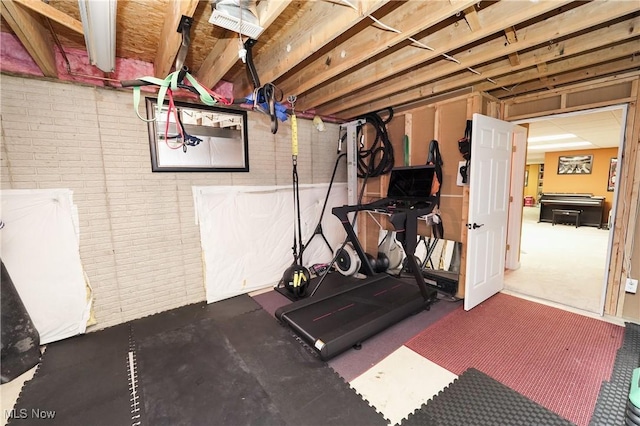 exercise area featuring brick wall