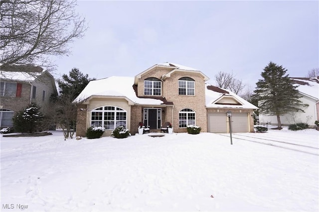 traditional-style house with brick siding and an attached garage