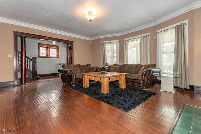 living room with stairs, wood-type flooring, and crown molding