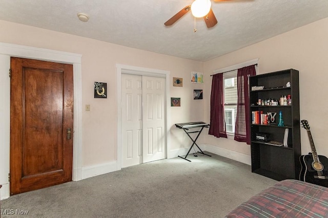 bedroom featuring a closet, carpet flooring, ceiling fan, and baseboards