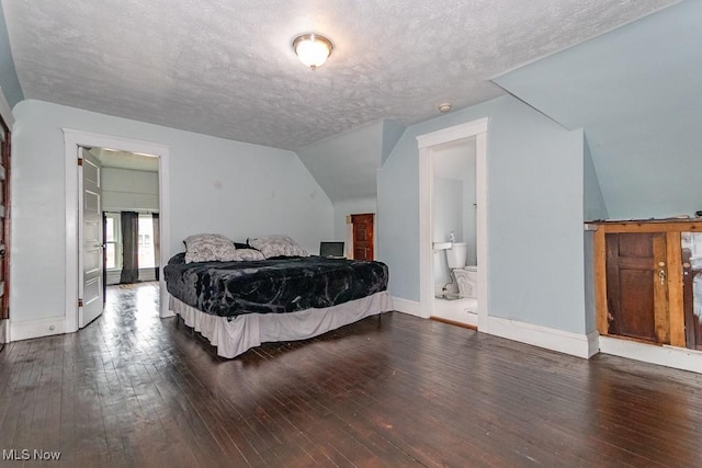 bedroom with a textured ceiling, hardwood / wood-style floors, lofted ceiling, and baseboards