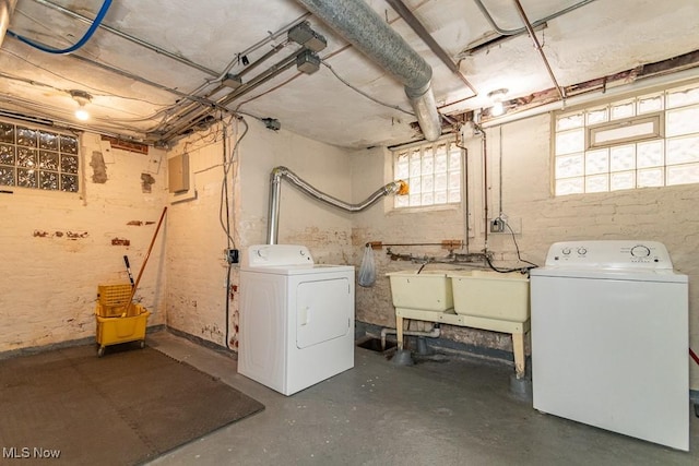 basement with separate washer and dryer and a sink