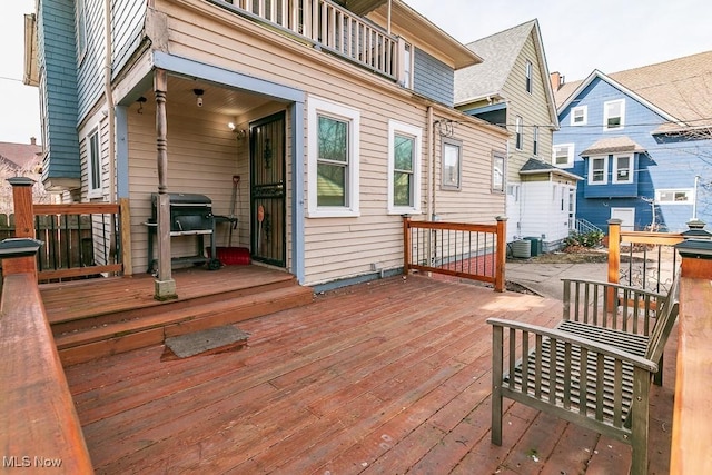 wooden terrace with grilling area and cooling unit