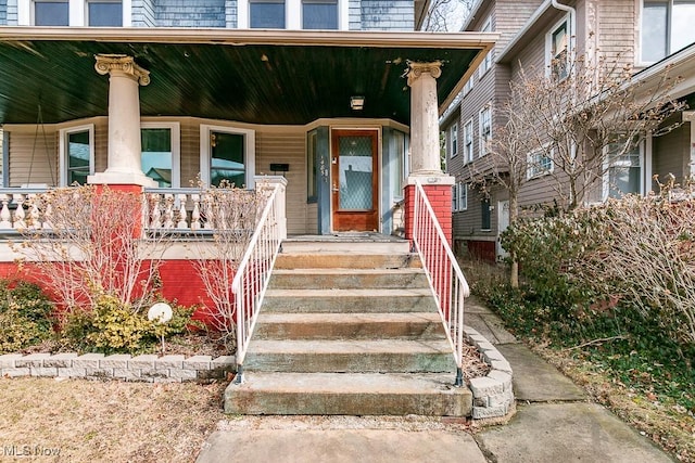 view of exterior entry featuring covered porch