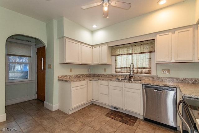 kitchen featuring arched walkways, visible vents, stainless steel dishwasher, a sink, and ceiling fan