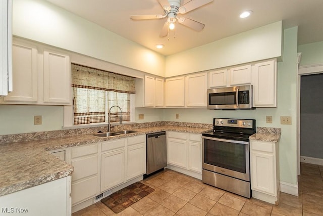 kitchen featuring recessed lighting, a sink, a ceiling fan, light countertops, and appliances with stainless steel finishes