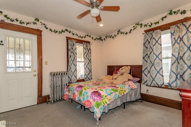 bedroom with baseboards, carpet flooring, a ceiling fan, and radiator