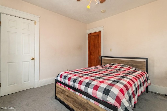 carpeted bedroom featuring ceiling fan and baseboards