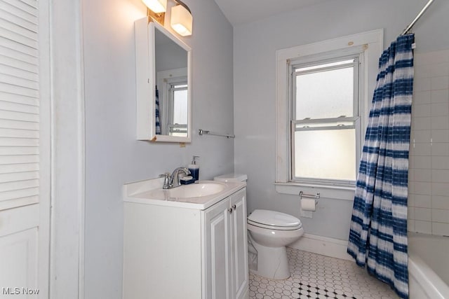 full bathroom featuring toilet, vanity, baseboards, tile patterned floors, and shower / bath combo with shower curtain