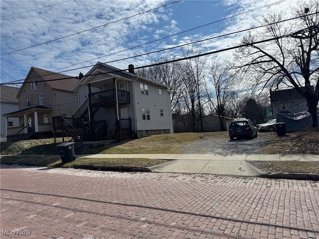 exterior space featuring driveway and a chimney