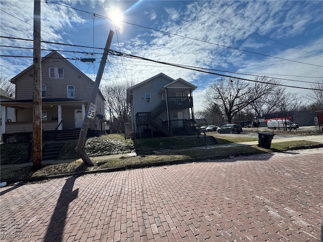 view of front of property with covered porch and stairway