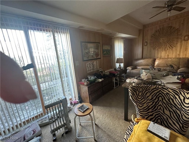 bedroom featuring wood walls and carpet