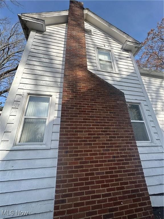 view of property exterior with a chimney