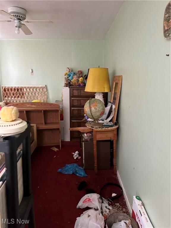 miscellaneous room with baseboards and a ceiling fan