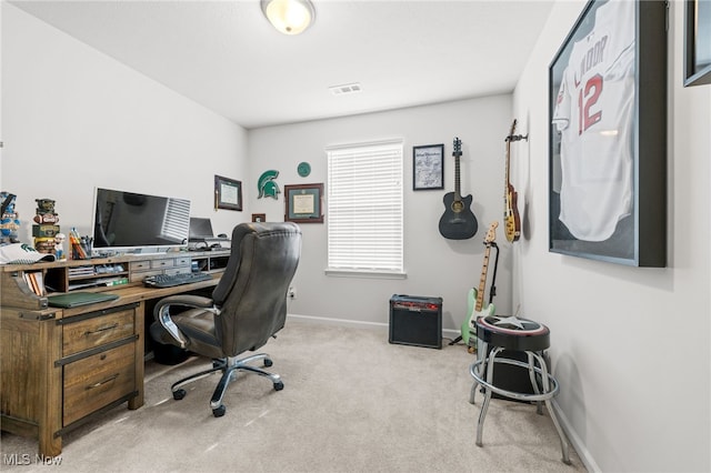 carpeted office space with baseboards and visible vents