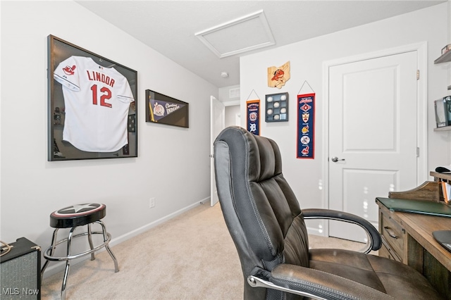 home office with attic access, light colored carpet, and baseboards