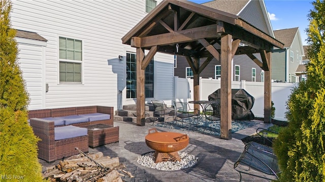 view of patio / terrace with a gazebo, area for grilling, fence, and an outdoor living space with a fire pit