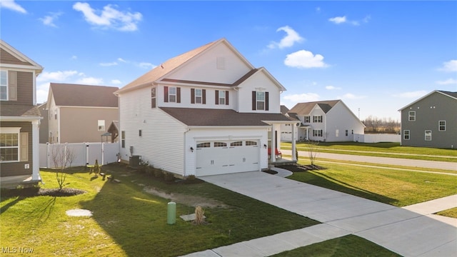 traditional-style home with a front yard, fence, a garage, a residential view, and driveway