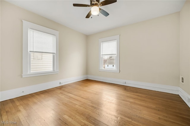 unfurnished room with ceiling fan, baseboards, and wood finished floors