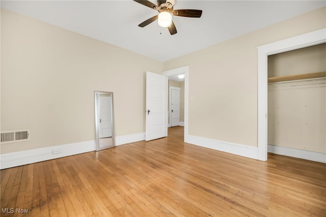 unfurnished bedroom featuring visible vents, baseboards, light wood-style flooring, ceiling fan, and a closet