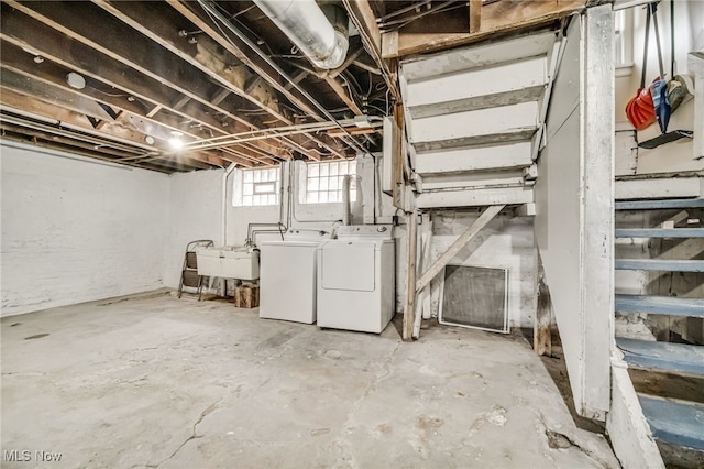 basement featuring a sink and washer and clothes dryer