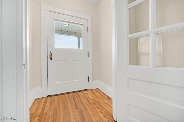 doorway to outside featuring light wood-type flooring and baseboards