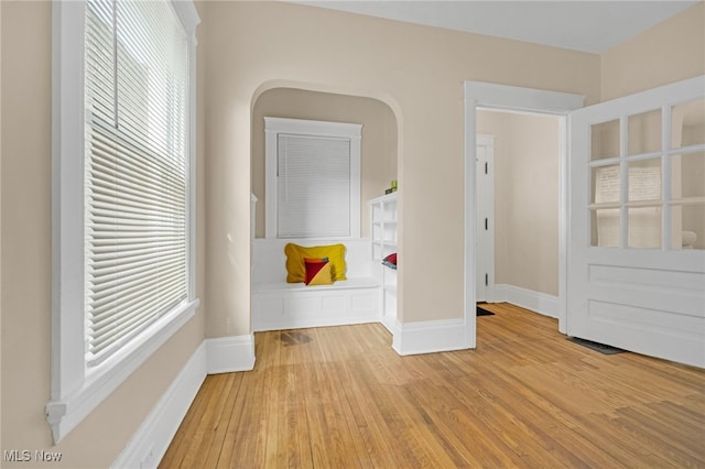 interior space with baseboards and wood finished floors