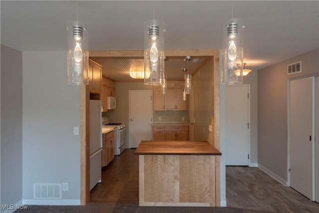 kitchen featuring light countertops, white appliances, visible vents, and hanging light fixtures