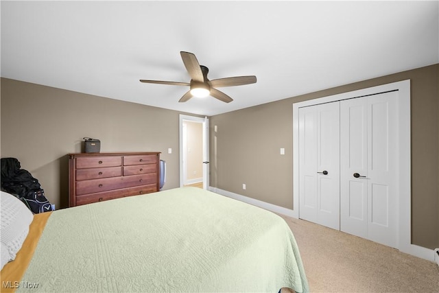 bedroom with a ceiling fan, a closet, and carpet flooring