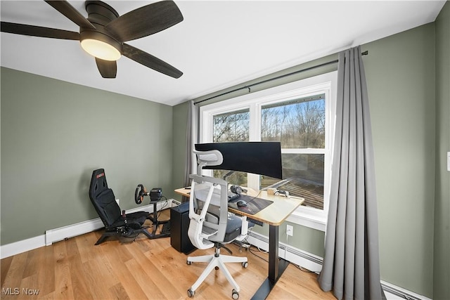 home office with light wood-type flooring, baseboards, a baseboard heating unit, and ceiling fan