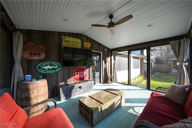 sunroom featuring vaulted ceiling and ceiling fan