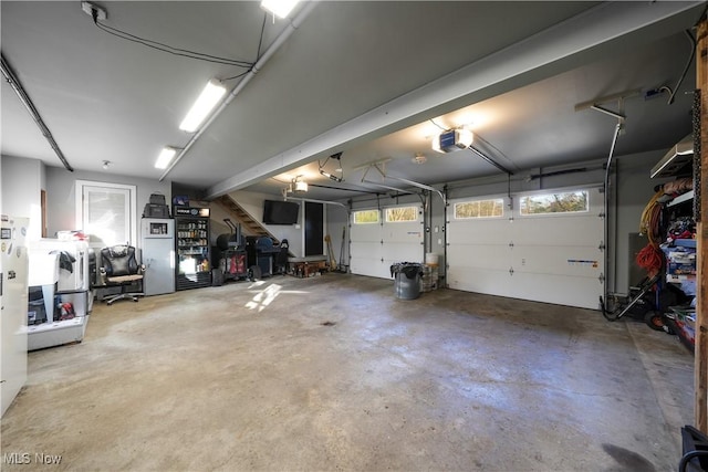 garage with fridge and a garage door opener