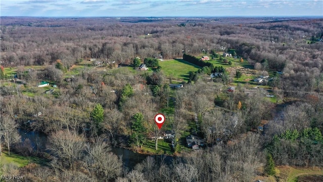 drone / aerial view featuring a wooded view