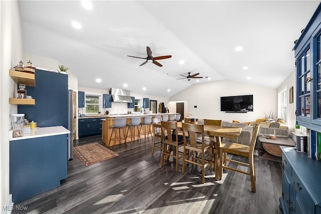 dining room featuring dark wood-style floors, vaulted ceiling, a ceiling fan, and recessed lighting