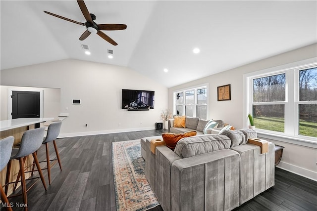 living room with vaulted ceiling, dark wood-style floors, visible vents, and baseboards