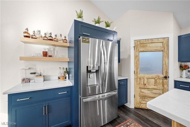 kitchen with blue cabinetry, stainless steel refrigerator with ice dispenser, and dark wood-style flooring