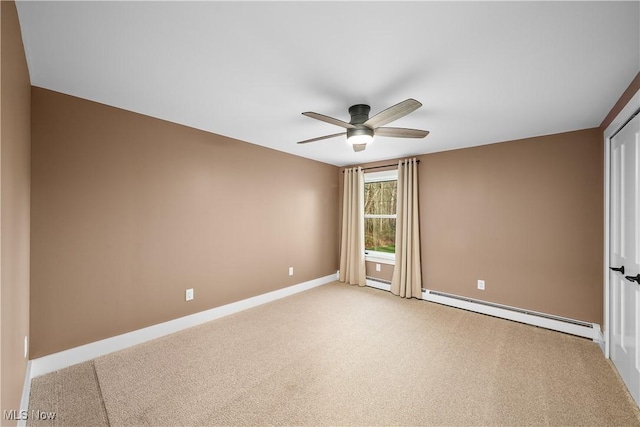 spare room with baseboards, light colored carpet, ceiling fan, and baseboard heating