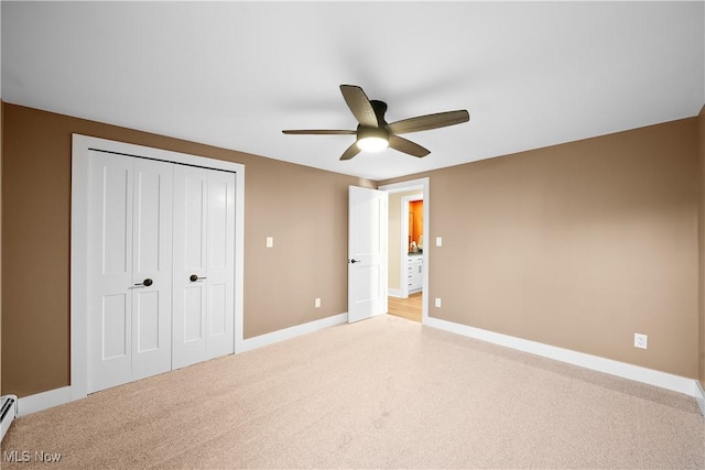 unfurnished bedroom featuring a closet, baseboard heating, a ceiling fan, light carpet, and baseboards