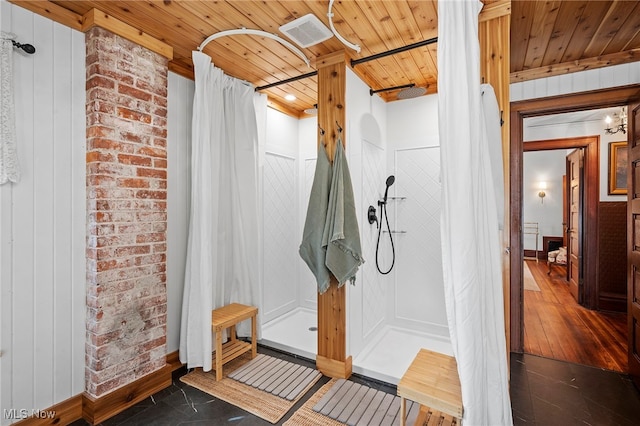 bathroom with wooden ceiling, brick wall, a shower with curtain, and visible vents