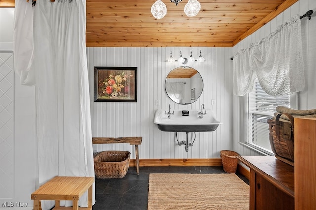 bathroom with tile patterned flooring, wooden ceiling, and baseboards