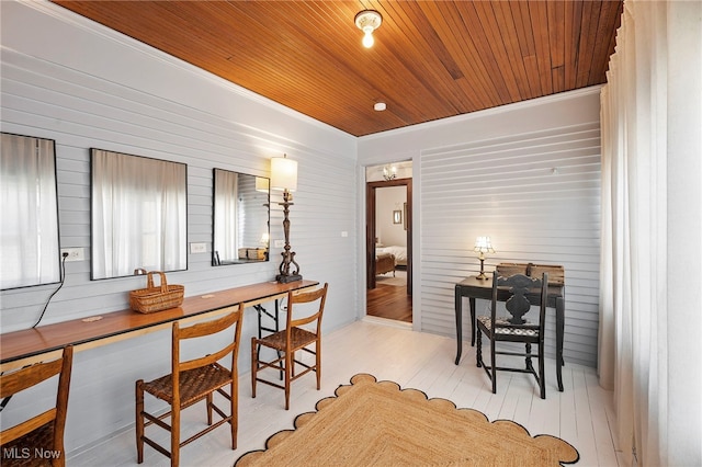 dining space featuring wood ceiling and wood finished floors