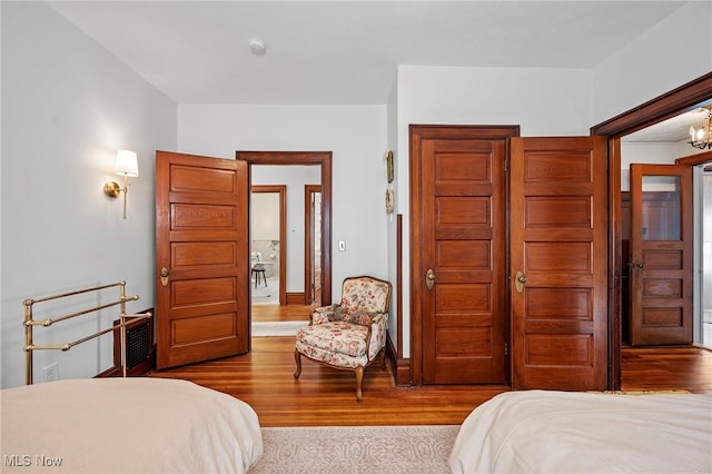 bedroom with a closet, wood finished floors, and baseboards