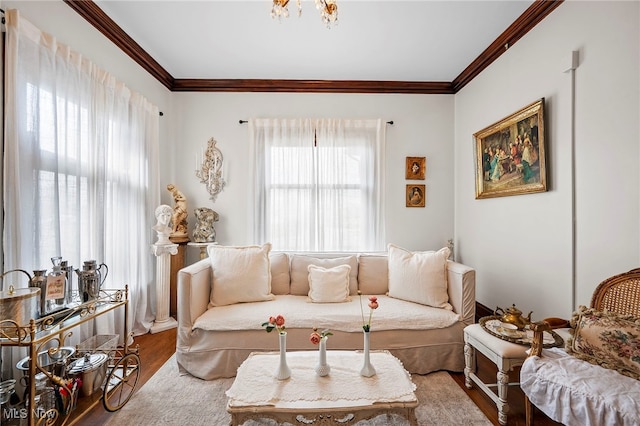 living area with ornamental molding and wood finished floors