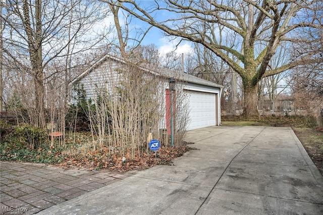 view of side of property with a detached garage