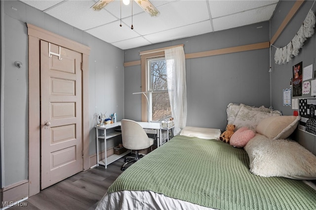 bedroom featuring a paneled ceiling and wood finished floors