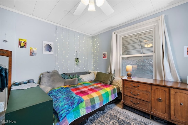 bedroom featuring a ceiling fan and crown molding