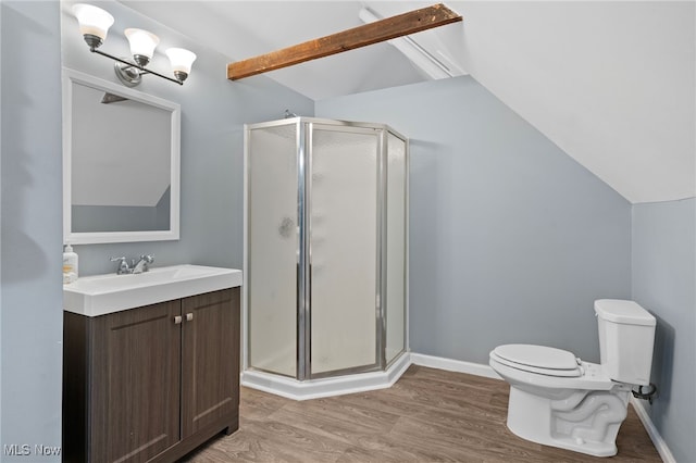 bathroom with toilet, wood finished floors, vaulted ceiling, vanity, and a shower stall