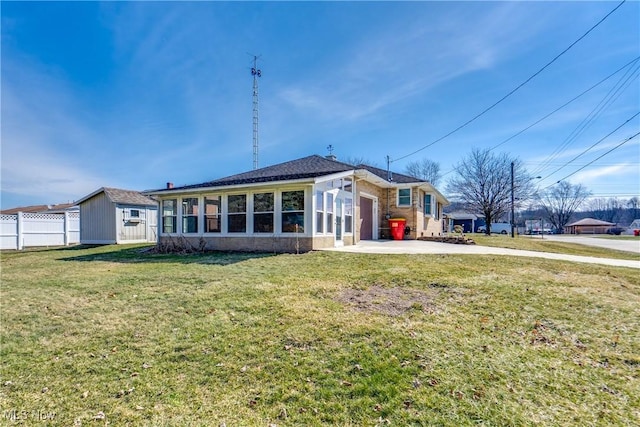 back of property featuring a garage, concrete driveway, a yard, and fence