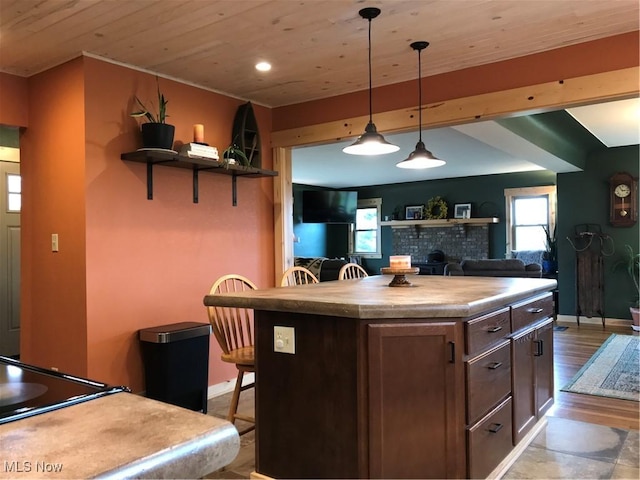 kitchen with a breakfast bar, wood ceiling, a center island, open shelves, and pendant lighting